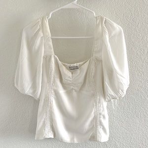 Women’s white corset top with sheer balloon sleeves
